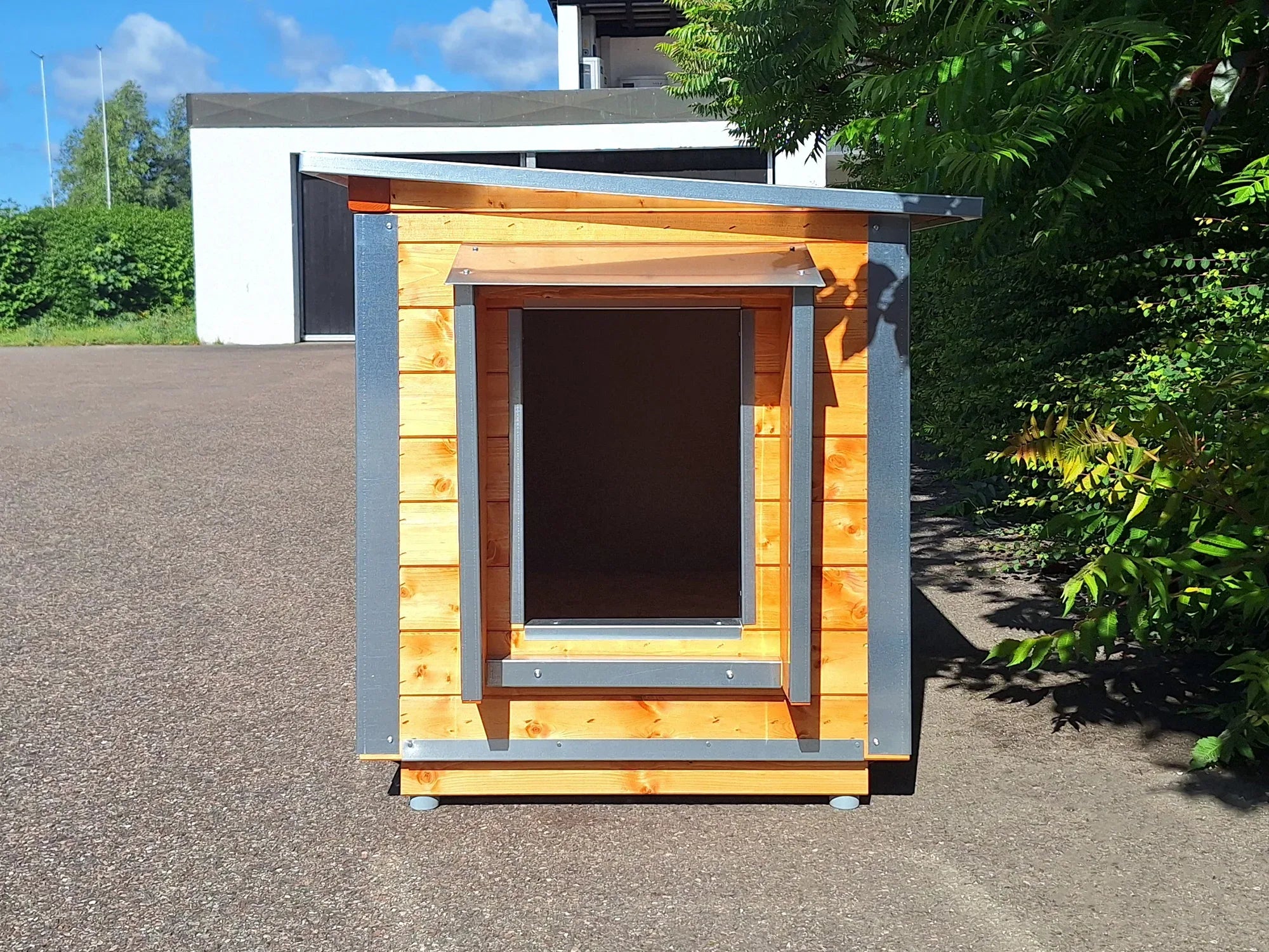 Isolierte Hundehütte für den Garten aus Holz und Metall mit Vordach