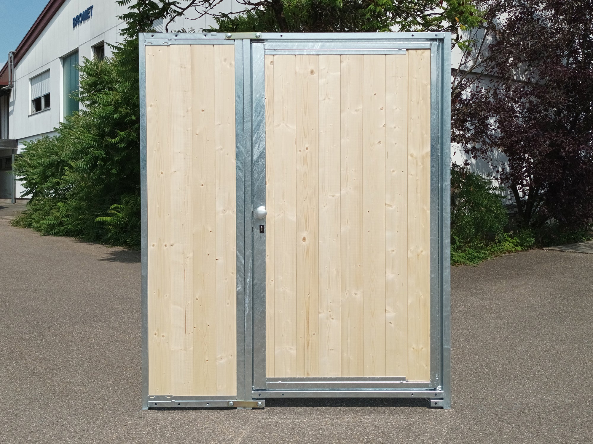 Eine Holzwand mit geschlossener Türe in der Breite von 1,5 m