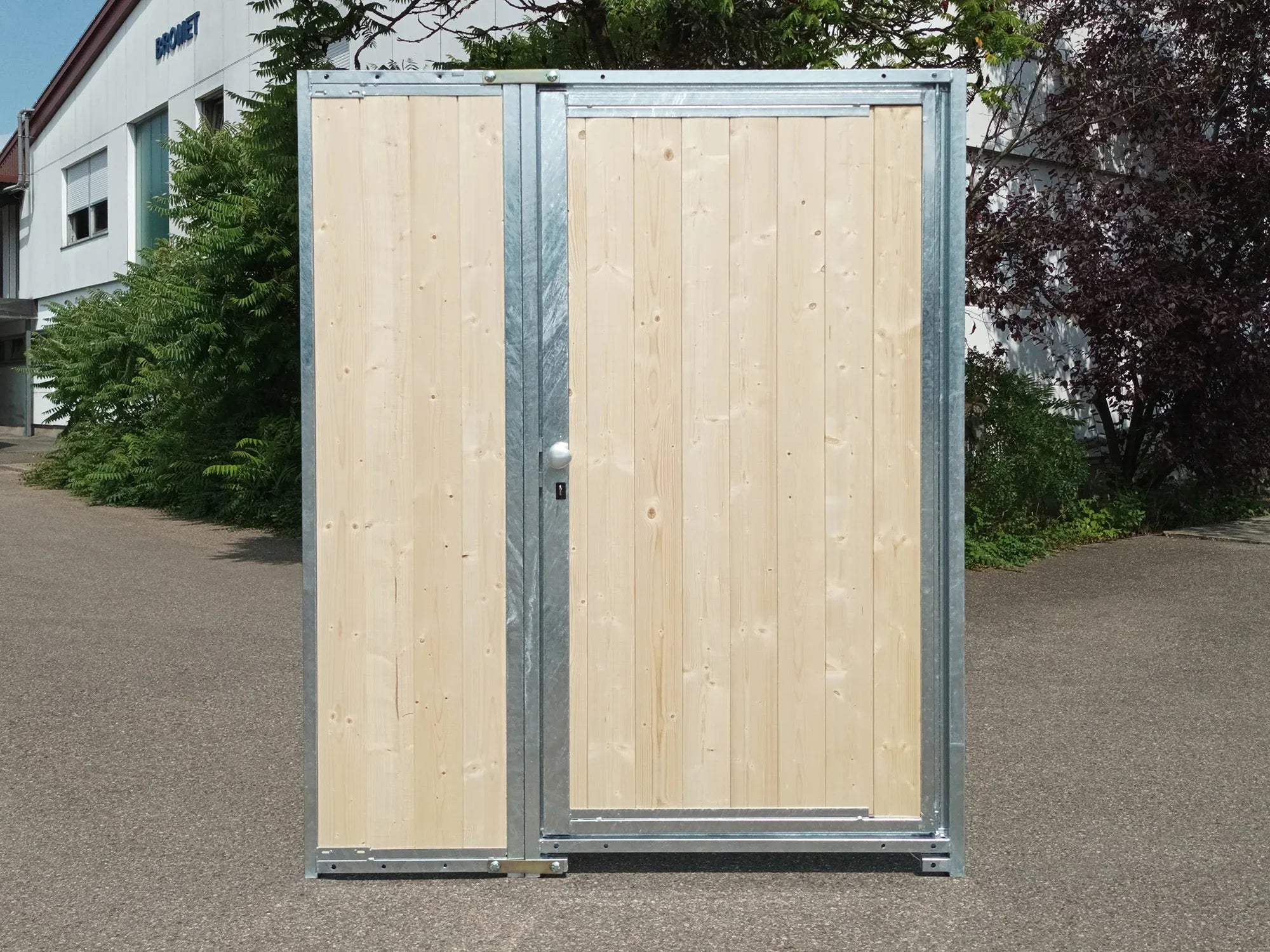 Eine Holzwand mit geschlossener Türe in der Breite von 1,5 m